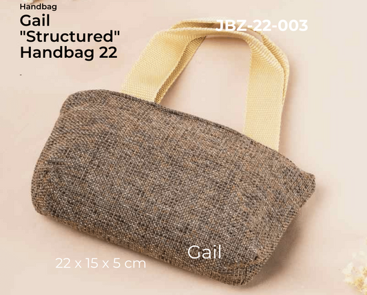 Brown textured handbag with a yellow handle on a beige background