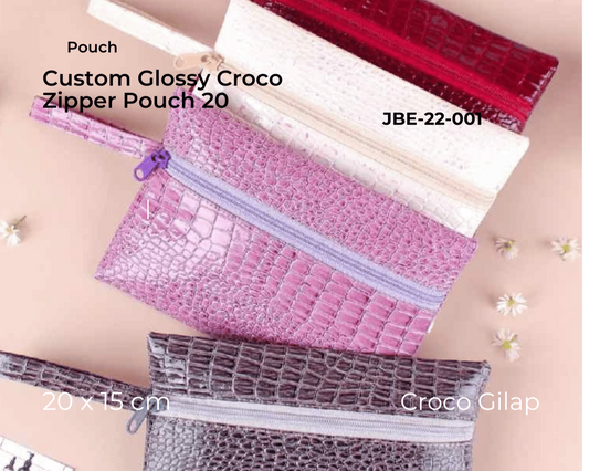 Collection of custom glossy croco zipper pouches in various colors on a beige background.