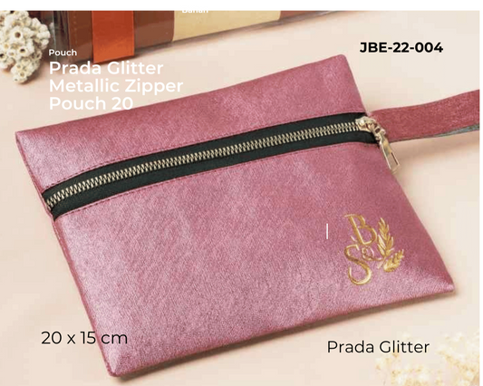 Pink glittery pouch with black zipper and Prada logo on a beige background